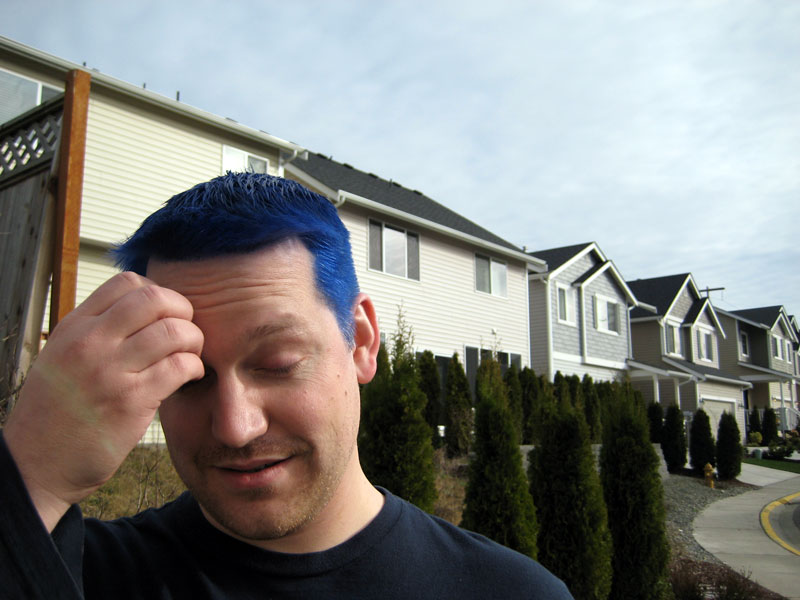 Adam with blue hair looking down